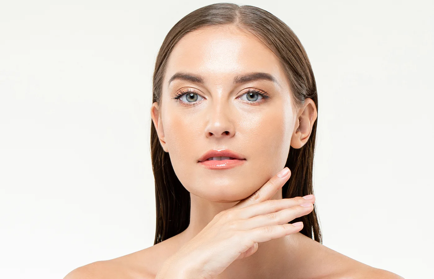 Woman gently touching her glowing skin in Lehi, UT | Avanti Medical Center