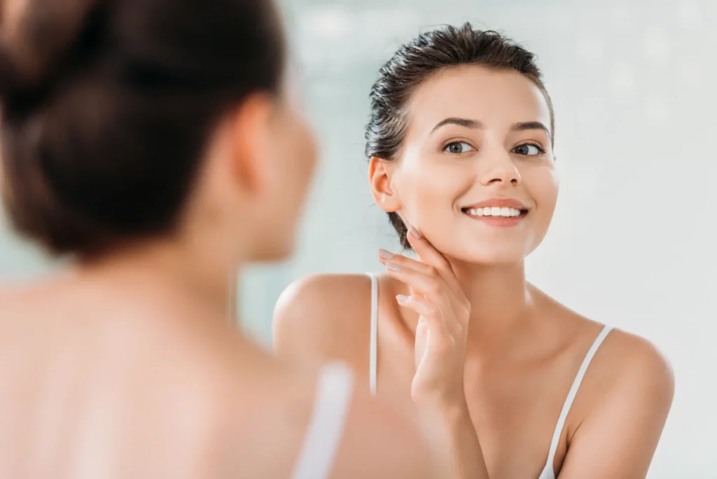 Young Woman Smiling Looking at Mirror in Lehi, UT | Avanti Medical Center